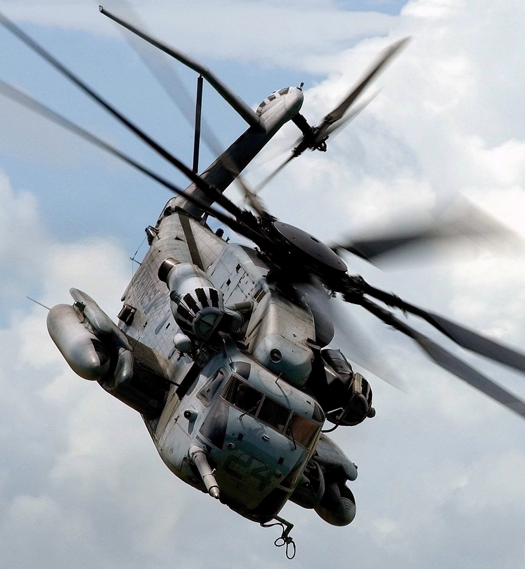 Close up image of helicopter in the air with focus on rotor blades