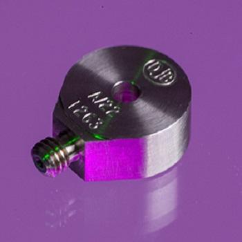 A close up shot of an A/22 accelerometer in a purple background