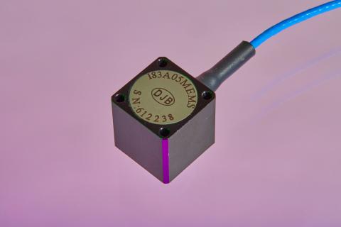 A shot of DJB Monoaxial accelerometer with Connector on a purple background