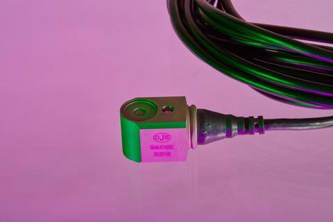 a shot of an A/140SC accelerometer in a purple background
