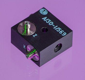 An A/30 dark cubed accelerometer shot in purple background