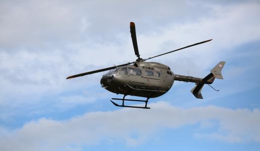 Helicopter in the air against blue sky