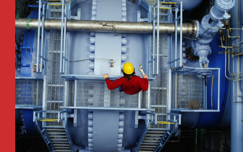 Shows Beran engineer on power station looking down over machinery
