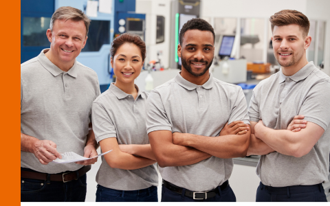 Group of engineers with folded arms smiling at the camera