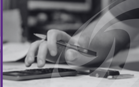 Image shows close up of male hand with calculator and pen