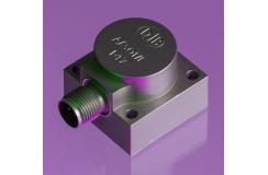 A close up shot of an A/301 accelerometer in a purple background