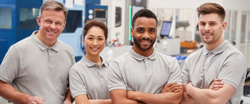 Group of engineers with arms folded smiling at the camera