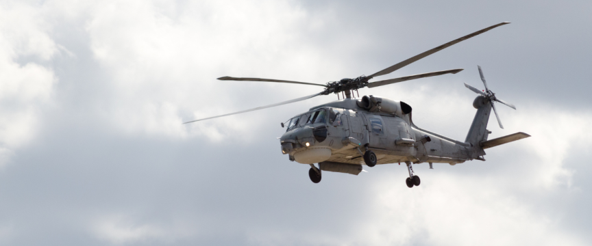 Helicopter in the air with a cloudy sky