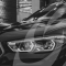 Black and white close up of premium car headlights