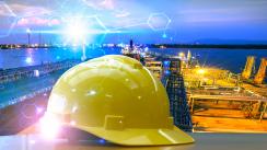 Yellow hard hat set against an industrial background