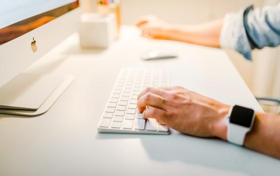 Hands on white keyboard