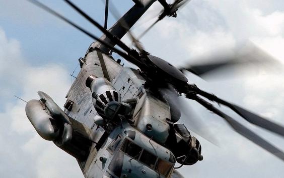 Close up image of helicopter in the air with focus on rotor blades