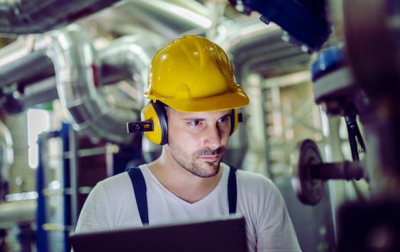 Engineer in hard hat working on power plant