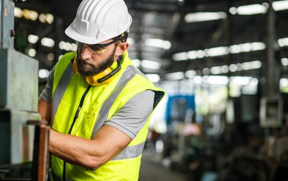 Engineer in hi-viz and hard hat on industrial plant