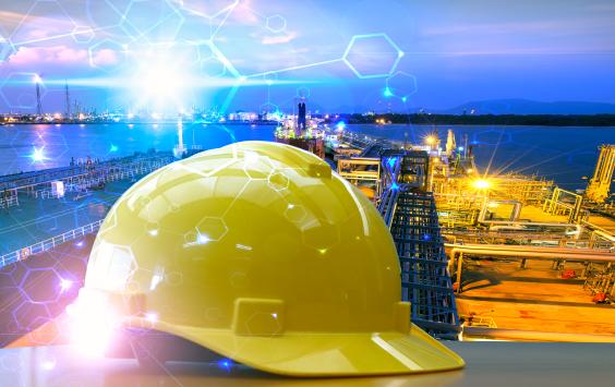 Yellow hard hat set against an industrial background