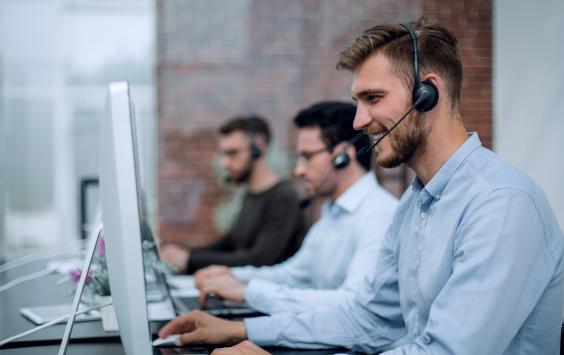 Man on phone in customer support centre
