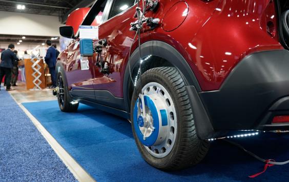 A red test car with testing equipment on the wheel