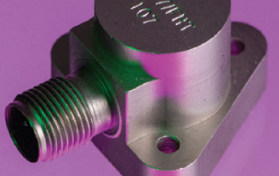 A close up shot of an A/107 accelerometer in a purple background