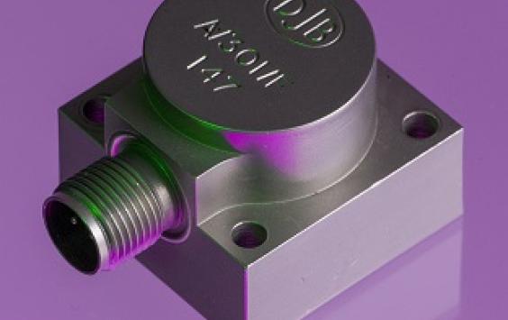 A close up shot of an A/301 accelerometer in a purple background