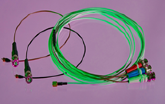 A set of DJB cables all looped round. One cable on the right is green with green, blue and red ends. On the left is a black and red cable separated