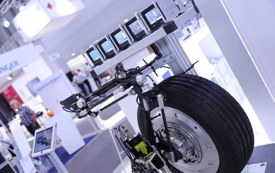 Car wheel on display at Automotive Testing Expo in Michigan