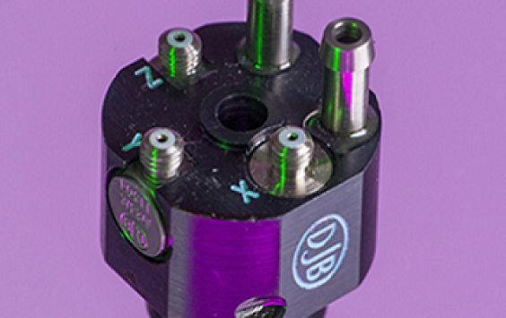 An A/133 accelerometer shot in purple background