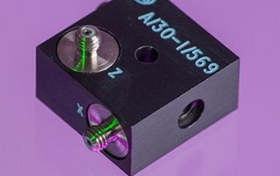 An A/30 dark cubed accelerometer shot in purple background