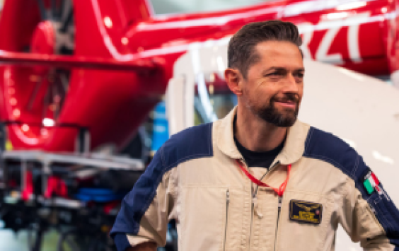 Man standing in front of red helicopter at the European Rotors Show 