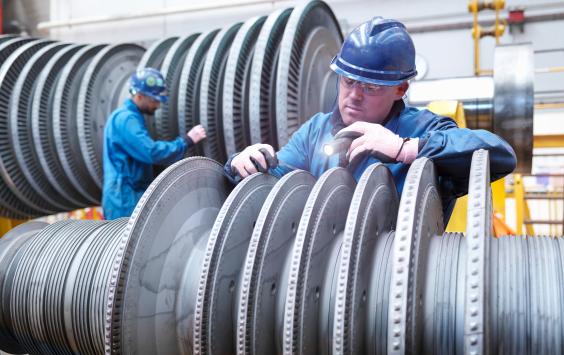 Engineers inspecting power station turbine during an outage
