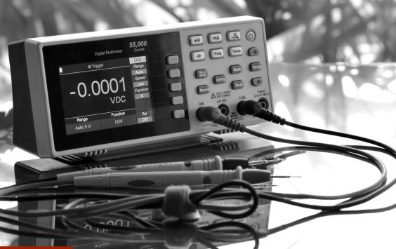 Digital measurement meter with test leads attached, in black and white.