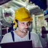Engineer in hard hat working on power plant