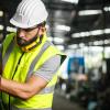 Engineer in hi-viz and hard hat on industrial plant