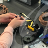 Person preparing a cable to fit a connector